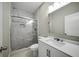 Contemporary bathroom featuring marble tile, glass shower, and modern vanity with ample lighting at 4140 Camaron Way, Snellville, GA 30039