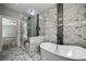 Modern bathroom with marble floors, soaking tub, glass shower and black tile stripe accent at 4140 Camaron Way, Snellville, GA 30039