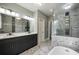 Modern bathroom with double sink vanity, marble floors, glass shower, and soaking tub at 4140 Camaron Way, Snellville, GA 30039