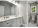 Bathroom featuring double vanity and large mirror, with an adjoining toilet and shower room at 4140 Camaron Way, Snellville, GA 30039