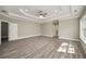 Bright bedroom with tray ceiling, ceiling fan and hardwood floors, including entry doors to bathroom at 4140 Camaron Way, Snellville, GA 30039