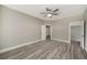 Bright bedroom with wood-look flooring, ceiling fan, and neutral paint tones at 4140 Camaron Way, Snellville, GA 30039