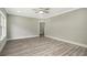 Large bedroom with wood-look floors, neutral paint, ceiling fan and ample natural light at 4140 Camaron Way, Snellville, GA 30039