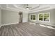 Bright bedroom with tray ceiling, ceiling fan, hardwood floors and natural light from the windows at 4140 Camaron Way, Snellville, GA 30039