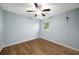 Cozy bedroom with ceiling fan, wood-look floors, and a window providing natural light at 4140 Camaron Way, Snellville, GA 30039