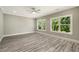 Bright bedroom with ceiling fan, hardwood floors and natural light from the windows at 4140 Camaron Way, Snellville, GA 30039