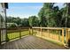 View of the wooden deck overlooking the backyard and treeline at 4140 Camaron Way, Snellville, GA 30039