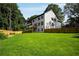 Backyard view of the home with a wood fence, deck, and lush lawn at 4140 Camaron Way, Snellville, GA 30039