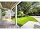 Charming covered front porch with brick flooring, white columns, and a view of the lush front yard and neighborhood at 4140 Camaron Way, Snellville, GA 30039