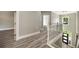 Upstairs hallway with hardwood floors, white railings, and views of the entryway below at 4140 Camaron Way, Snellville, GA 30039
