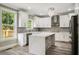 Well-lit kitchen showcasing a stylish island with quartz countertop and ample cabinet space at 4140 Camaron Way, Snellville, GA 30039