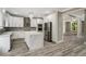 Modern kitchen featuring white cabinets, a marble island, stainless steel appliances, and stylish backsplash at 4140 Camaron Way, Snellville, GA 30039