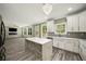 Open concept kitchen featuring a quartz island, white cabinetry, and stainless steel appliances at 4140 Camaron Way, Snellville, GA 30039