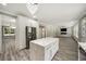 Open kitchen with white cabinets, an island with marble countertop, and stainless steel appliances, flowing into the living area at 4140 Camaron Way, Snellville, GA 30039