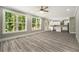 Open-concept living area connecting to a modern kitchen, with abundant natural light from large windows at 4140 Camaron Way, Snellville, GA 30039