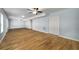 Expansive living room with multiple ceiling fans, wood-look flooring, and a closet with double doors at 4140 Camaron Way, Snellville, GA 30039