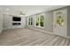 Bright living room boasts a stacked stone accent wall with a fireplace and large windows at 4140 Camaron Way, Snellville, GA 30039