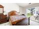 Bedroom with wood bed frame and patio access provides a serene retreat with outdoor connection at 5069 Kathryn Glen Dr, Acworth, GA 30101