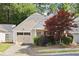 View of the front of the property showcasing the well-kept lawn and partial two car garage at 5069 Kathryn Glen Dr, Acworth, GA 30101