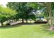 Lush green community greenspace with mature trees and a covered gazebo in the background at 5069 Kathryn Glen Dr, Acworth, GA 30101