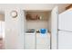 Bright laundry closet features a stacked washer and dryer, with convenient overhead shelving for storage at 5069 Kathryn Glen Dr, Acworth, GA 30101