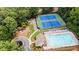 Aerial view of community featuring a pool, playground, tennis courts, and charming landscaping at 1765 Redbud Way, Cumming, GA 30041
