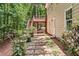 Exterior view showcasing a well-maintained yard with stone pathway and access to a spacious deck at 1765 Redbud Way, Cumming, GA 30041