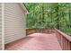 Spacious wooden deck offering a private outdoor retreat surrounded by lush greenery and wooded views at 1765 Redbud Way, Cumming, GA 30041