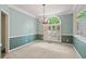 Formal dining room featuring stylish two-tone paint, carpeted floors, and a hanging chandelier at 1765 Redbud Way, Cumming, GA 30041