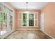 Bright dining room with tiled floor, backyard access, and large window with white shutters at 1765 Redbud Way, Cumming, GA 30041