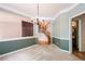 Elegant dining room with decorative chandelier, two-tone walls, and seamless flow to the staircase at 1765 Redbud Way, Cumming, GA 30041