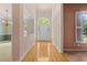 Welcoming entryway with hardwood floors, transom window above the front door, and open sight lines at 1765 Redbud Way, Cumming, GA 30041