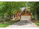 Beautiful two-story brick home featuring an attached two car garage and lush landscaping at 1765 Redbud Way, Cumming, GA 30041