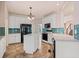 Charming kitchen with an island, tile backsplash, white cabinetry, and black appliances at 1765 Redbud Way, Cumming, GA 30041