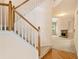 Staircase leading to the home's upper level, view of the living room with a stone fireplace at 1765 Redbud Way, Cumming, GA 30041