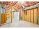 Unfinished basement area with exposed ceiling and wooden framing provides opportunity for customization at 2359 Saint Kennedy Ln, Buford, GA 30518