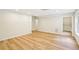 Finished basement with wood flooring and white doors at 2359 Saint Kennedy Ln, Buford, GA 30518