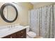 Cozy bathroom featuring a vanity with marble countertop, framed mirror, toilet, and shower with patterned curtain at 2359 Saint Kennedy Ln, Buford, GA 30518