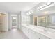 Bright bathroom with double sinks, white cabinets, and glass enclosed shower at 2359 Saint Kennedy Ln, Buford, GA 30518