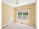 Comfortable bedroom with neutral walls, carpet, a ceiling fan, and window providing natural light at 2359 Saint Kennedy Ln, Buford, GA 30518