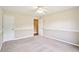 Bedroom boasts neutral carpet, wall paneling, and a doorway at 2359 Saint Kennedy Ln, Buford, GA 30518