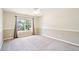 Well-lit bedroom features large window, wall paneling, and neutral carpet at 2359 Saint Kennedy Ln, Buford, GA 30518