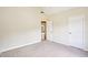 Neutral bedroom featuring plush carpet, a doorway, and a white paneled door at 2359 Saint Kennedy Ln, Buford, GA 30518