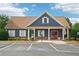 Exterior view of a community clubhouse with landscaped front and parking area at 2359 Saint Kennedy Ln, Buford, GA 30518