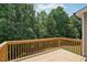 Wooden deck overlooking lush green landscape with beautiful trees offers privacy and outdoor enjoyment at 2359 Saint Kennedy Ln, Buford, GA 30518