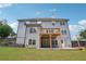 Rear exterior view showcasing deck, patio and backyard space at 2359 Saint Kennedy Ln, Buford, GA 30518