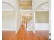 View into the home's foyer featuring hardwood floors, high ceilings and a staircase to the second level at 2359 Saint Kennedy Ln, Buford, GA 30518