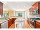 Well-lit kitchen with wooden cabinets, granite countertops, stainless steel appliances, and center island at 2359 Saint Kennedy Ln, Buford, GA 30518