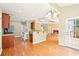 Open-concept kitchen with wood floors, island and breakfast bar conveniently located near the living room at 2359 Saint Kennedy Ln, Buford, GA 30518