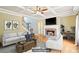 The living room features a cozy fireplace, hardwood floors, trey ceilings and is virtually staged at 2359 Saint Kennedy Ln, Buford, GA 30518